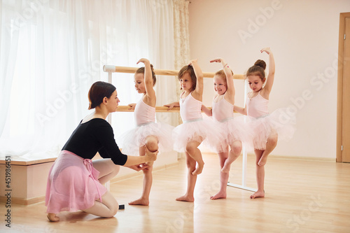 Practicing pose. Little ballerinas preparing for performance