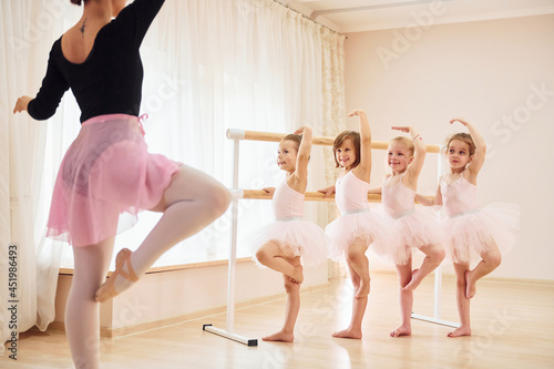 Practicing pose. Little ballerinas preparing for performance