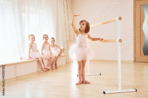 Practicing dance moves. Little ballerinas preparing for performance