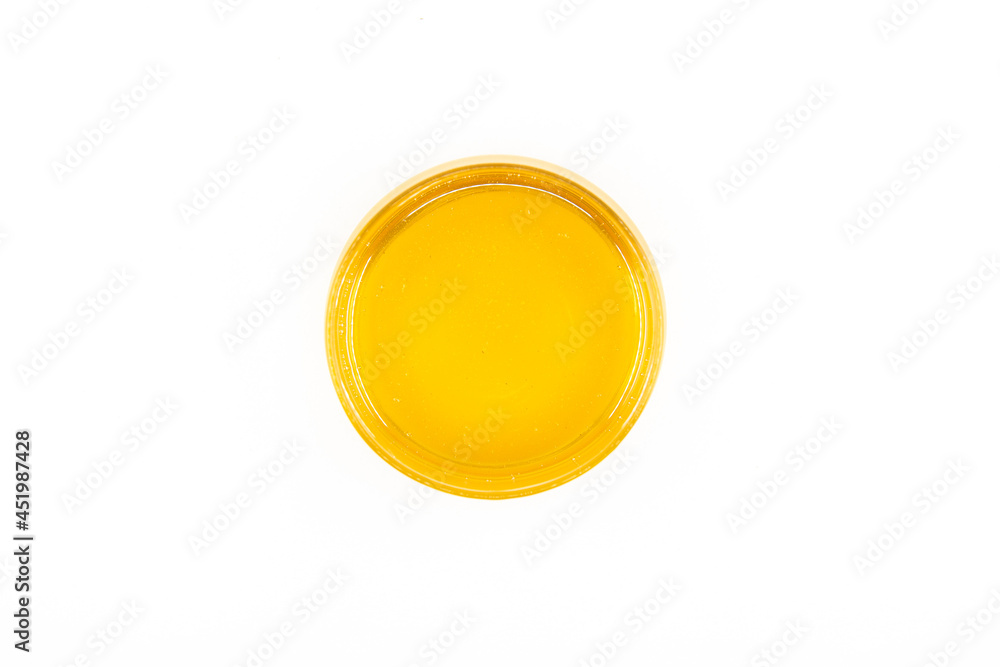 Organic and fresh honey in glass bowl isolated on white background. Healthy food concept. Organic and fresh honey in glass bowl isolated on white background. Healthy food concept.