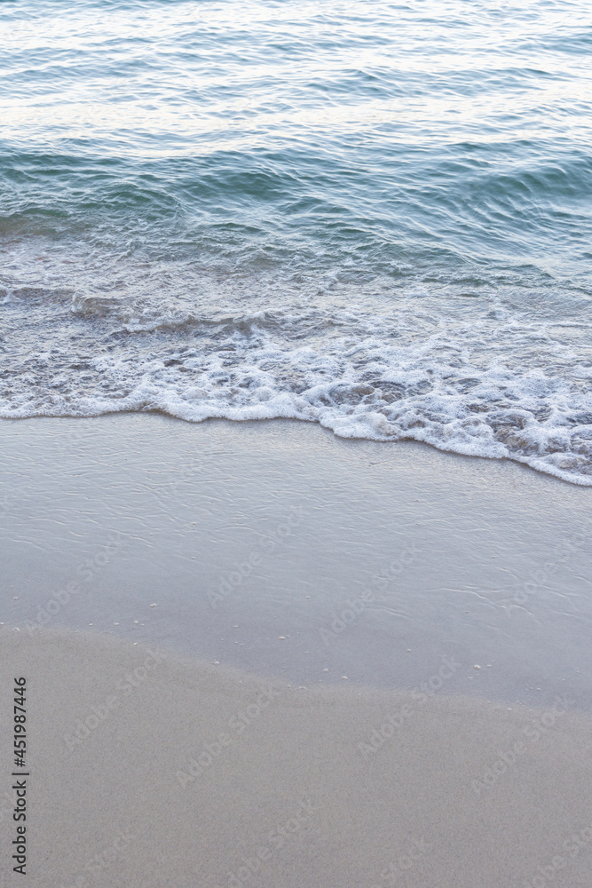 Sea coast in summer, the wave rolls over the sandy shore Sea coast in summer, the wave rolls over the sandy shore
