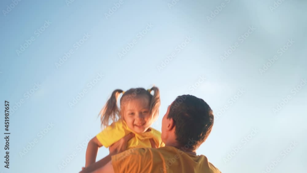father throw up his daughter. parent play with baby a kid in park silhouette in blue sky. happy family kid dream concept. father throw his daughter up of silhouette. sun happy family in the park father throw up his daughter. parent play with baby a kid in park silhouette in blue sky. happy family kid dream concept. father throw his daughter up of silhouette. sun happy family in the park