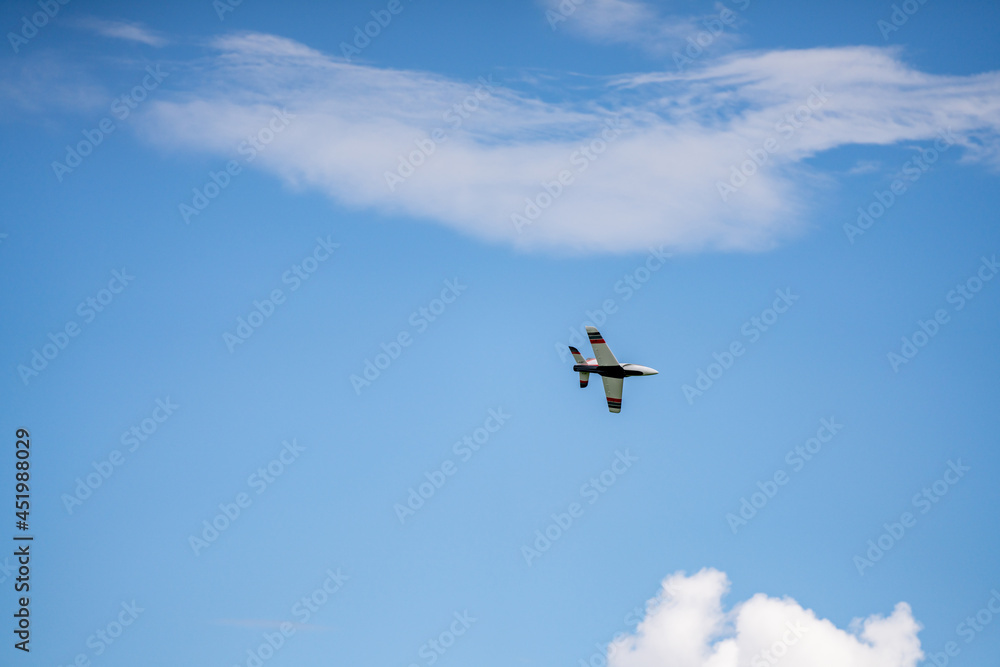 Remote controlled aircraft flying on blue sky Remote controlled aircraft flying on blue sky