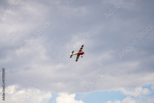RC propeller aircraft flying on a cloudy sky