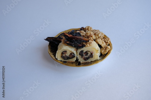 dried fruits and nuts roll. dried persimmon fruit and sunflower seeds baked in a roll. healthy and energy food concept