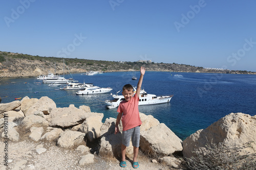 Photos Tourist boy and Cape Greco or Capo Greco, Famagusta Bay, Ayia Napa Municipality, Cyprus