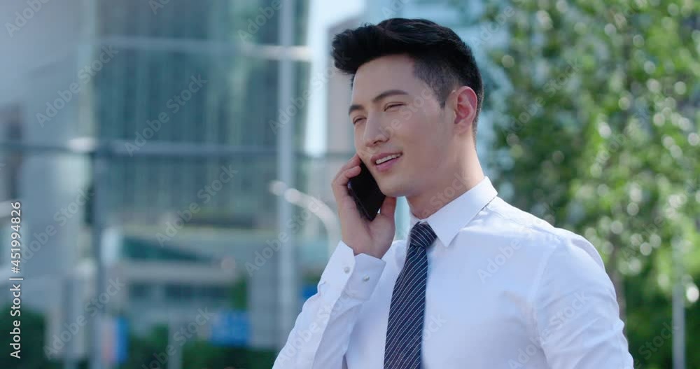 Confident young businessman using smartphone on street,4K Confident young businessman using smartphone on street,4K