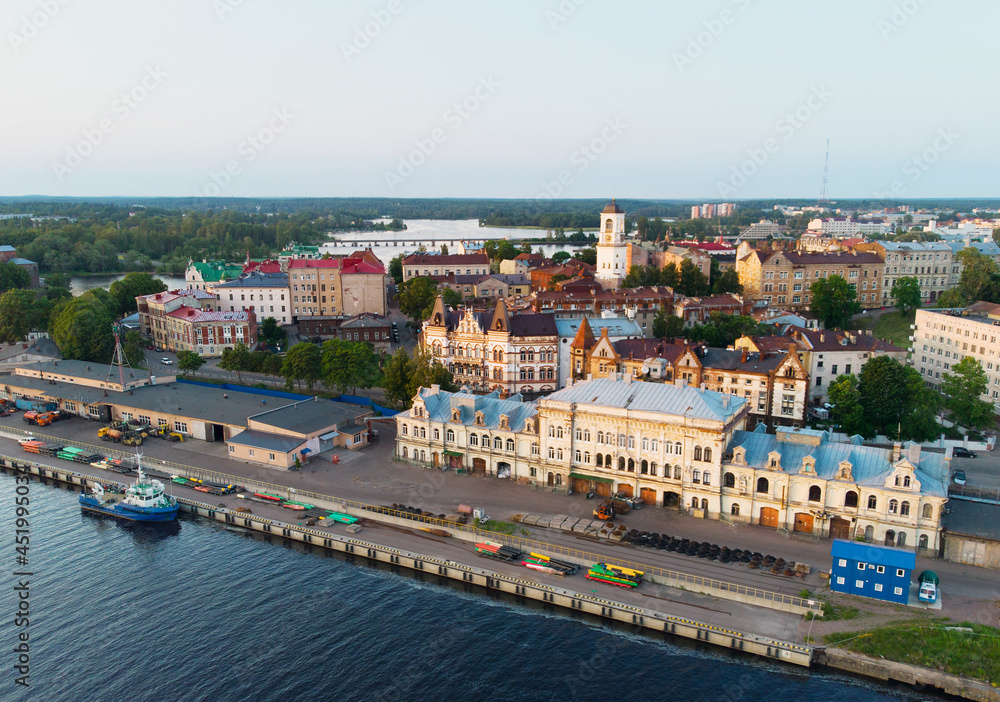 Aerial view of Vyborg city and port. Clock tower, houses, castle, ship. Russia