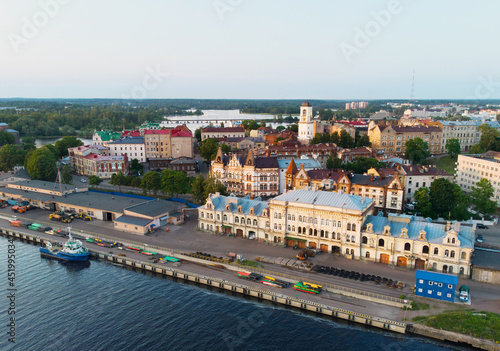 Aerial view of Vyborg city and port. Clock tower, houses, castle, ship. Russia
