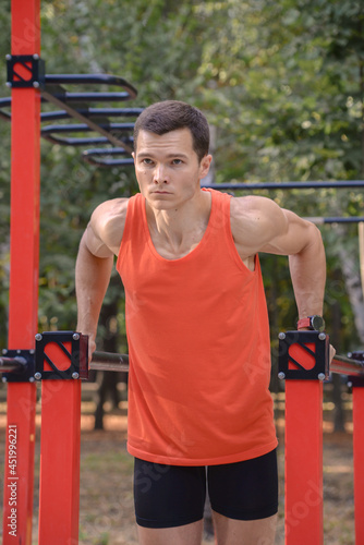young athletic man goes in for sports in the park. outdoor fitness, healthy lifestyle