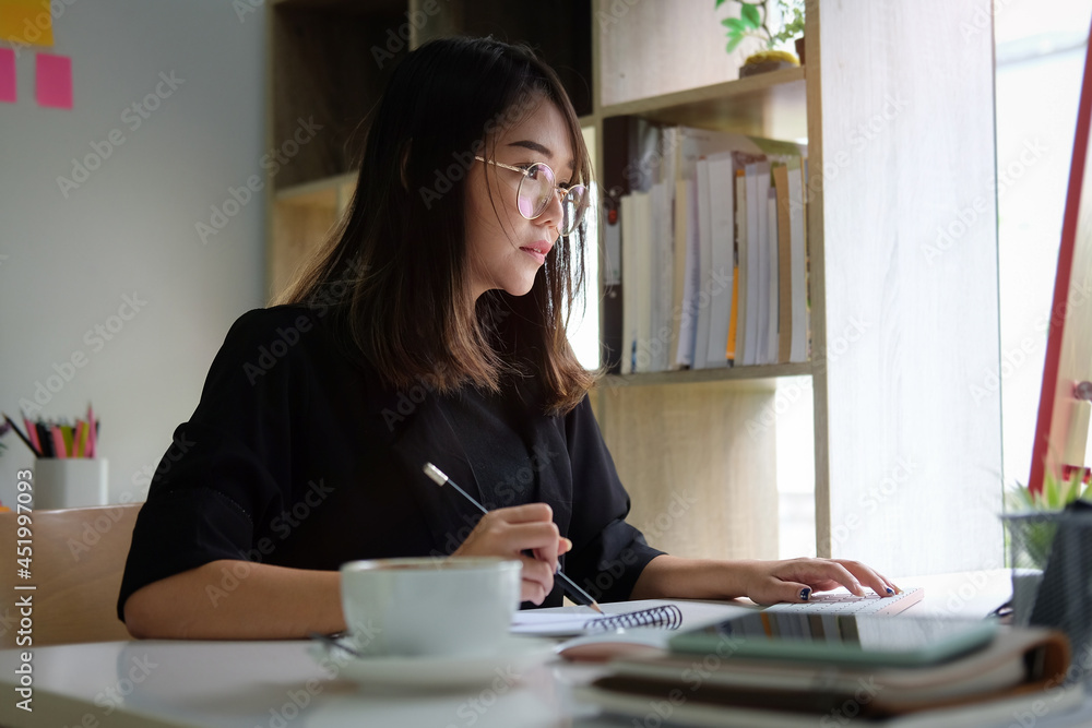 Businesswoman analysing business data on computer. Businesswoman analysing business data on computer.