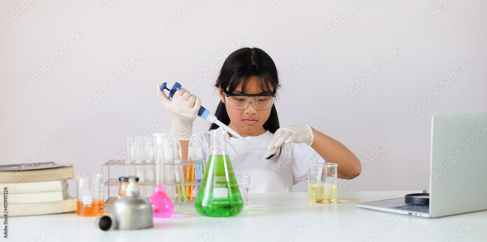 Little girl doing experiments in the laboratory. Science and education. Little girl doing experiments in the laboratory. Science and education.