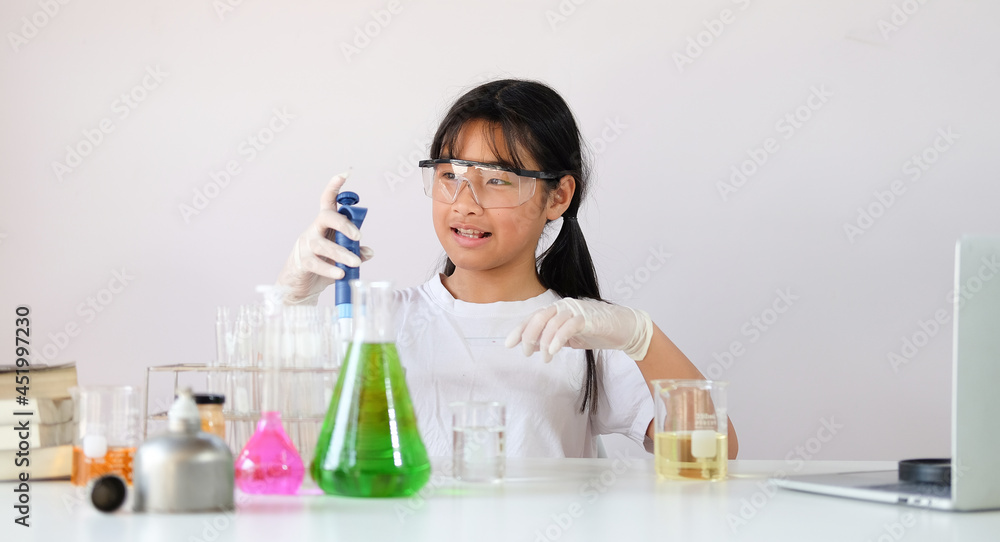 Asian girl doing chemical experiment in laboratory. Asian girl doing chemical experiment in laboratory.