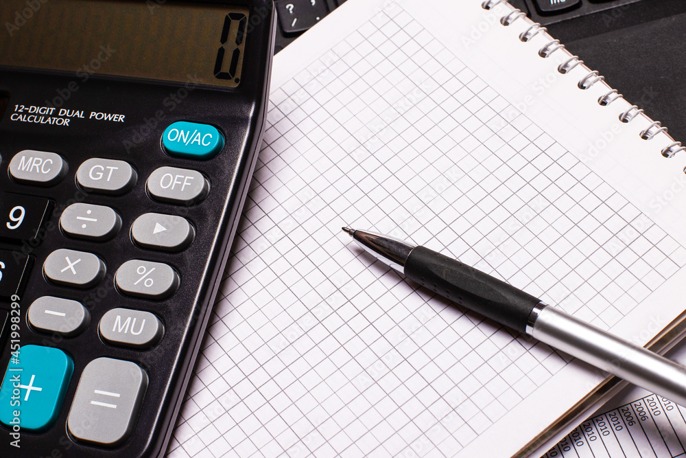 On the desktop is a notebook, calculator and pen. Business concept. Workplace close up On the desktop is a notebook, calculator and pen. Business concept. Workplace close up