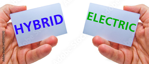 man hands holding cardstocks with the words hybrid and electrical.