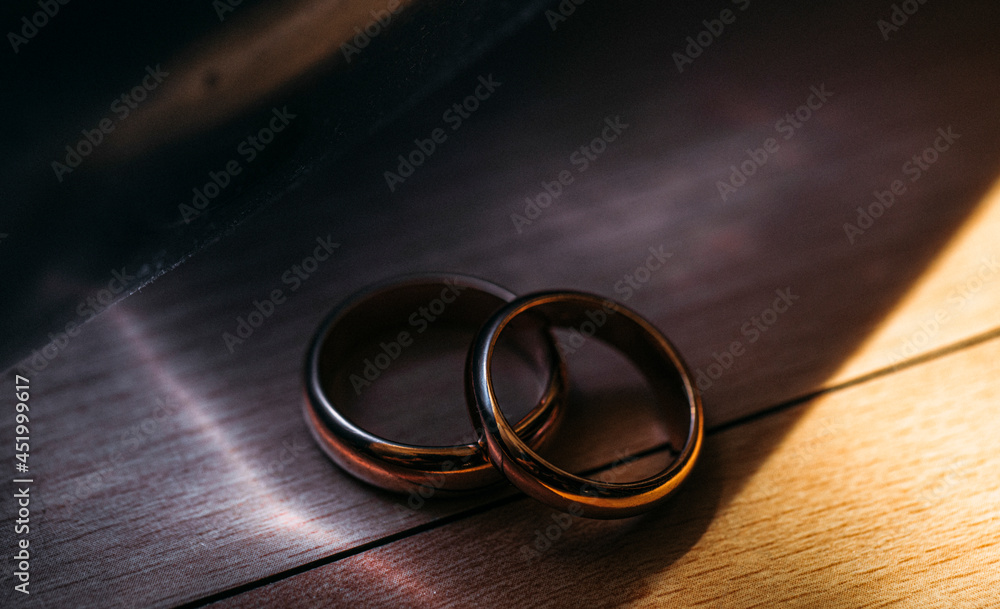 wedding rings on a wooden table