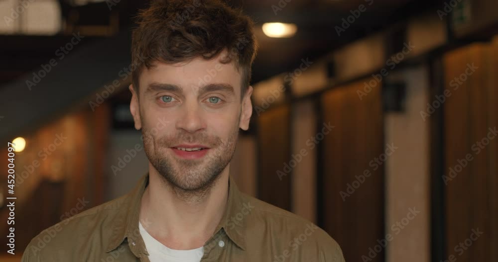 Portrait of Smiling Successful Adult Man Entrepreneur Owner standing indoors. Confident Attractive Male wears Casual Clothes looking into camera. Cheerful Guy Manager or Startupper. Millennial Guy. Portrait of Smiling Successful Adult Man Entrepreneur Owner standing indoors. Confident Attractive Male wears Casual Clothes looking into camera. Cheerful Guy Manager or Startupper. Millennial Guy.