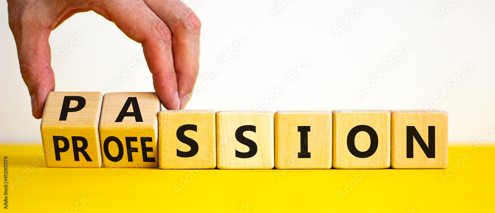 Passion or profession symbol. Businessman turns wooden cubes and changes the word profession to passion. Beautiful yellow table, white background, copy space. Business, passion or profession concept. - obrazy, fototapety, plakaty 