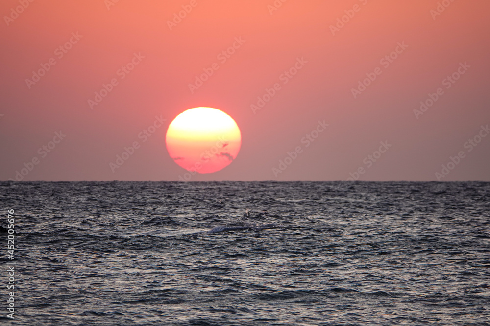 A great view of the sun over the sea on the island at sunset. orange sunset over the sea. A great view of the sun over the sea on Imbros island at orange sunset . Gökçeada sunset view