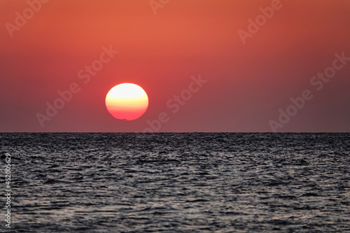 Fototapeta Naklejka Na Ścianę i Meble -  A great view of the sun over the sea on the island at sunset