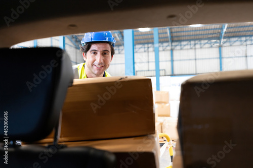 Wallpaper Mural male factory worker loading and moving boxes in to the car from warehouse storage Torontodigital.ca