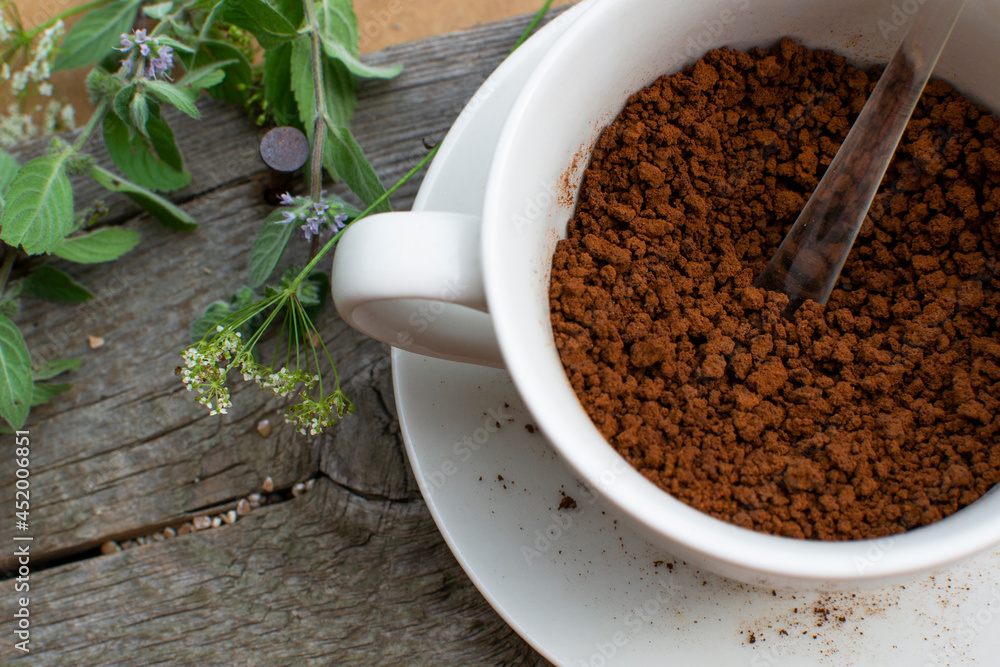 Composition: Herbs and instant coffee in a porcelain cup. Composition: Herbs and instant coffee in a porcelain cup.