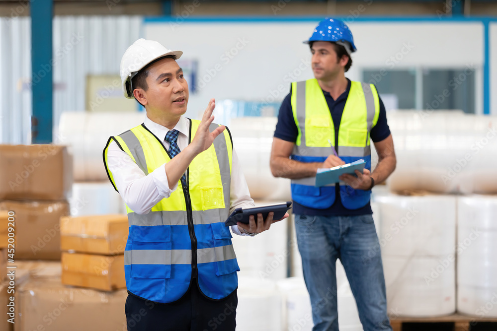 factory worker or engineer using tablet for preparing a job in warehouse storage factory worker or engineer using tablet for preparing a job in warehouse storage