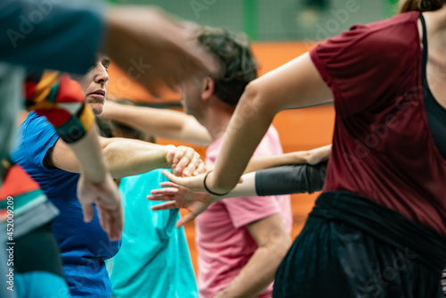 dancers contact hands in contact improvisation against a background of jam performance intentionally with motion blur ond defocus bokeh