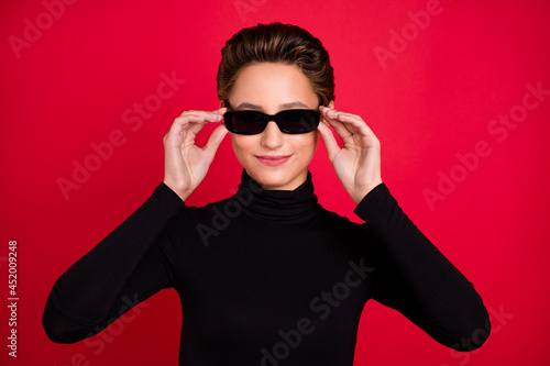 Photo of young charming attractive cool woman wear hold hands sunglass lady isolated on red color background © deagreez