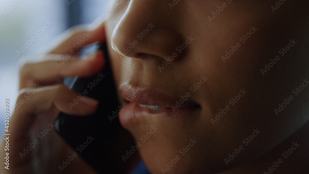 Close up african business woman biting lips. Manager calling on mobile phone