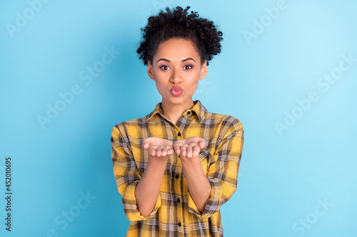 Photo of young attractive black girl pouted lips send air kiss romantic feelings isolated over blue color background