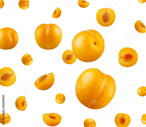 Perfectly retouched whole yellow plums fly in space isolated on white background.