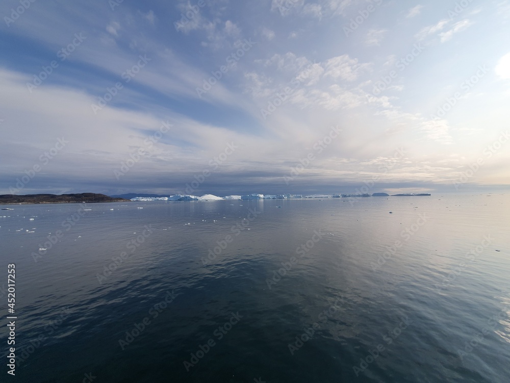 Evening mood over disco bay and ice barrier near Ilulissat, Greenland