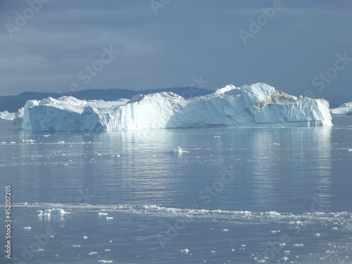 The mighty ice barrier near Ilulissat, Greenland, is formed from glacier ice of the Semeq Kujallek glacier floating through the kanga icefjord towards the open sea photo