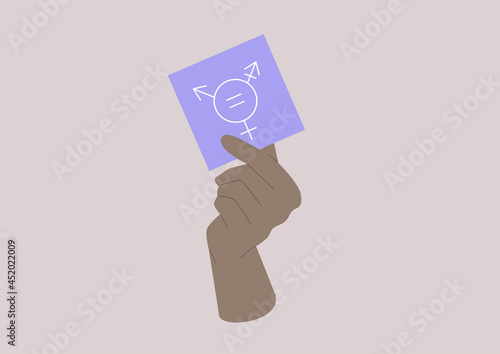 A hand holding a note with a gender equality symbol on it