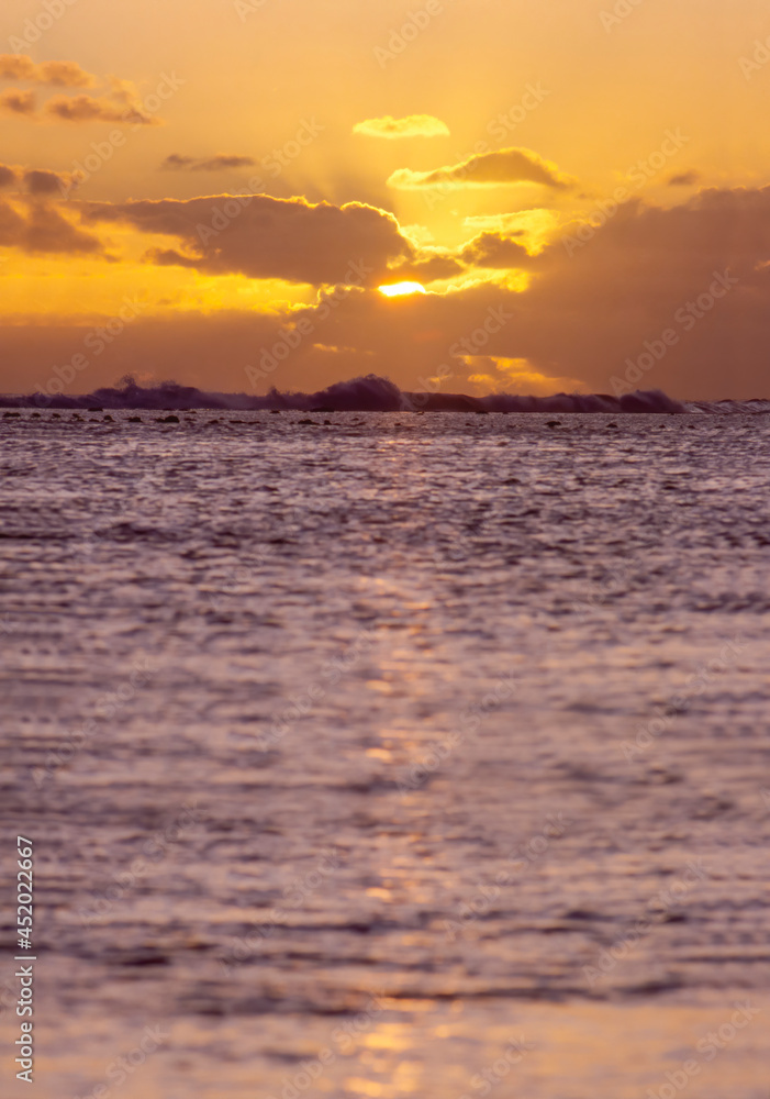 Sun setting behind the clouds over the ocean Sun setting behind the clouds over the ocean