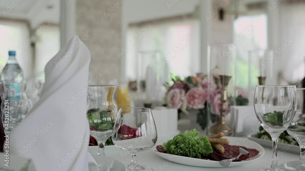 festive table in a restaurant at a wedding with food and glasses festive table in a restaurant at a wedding with food and glasses