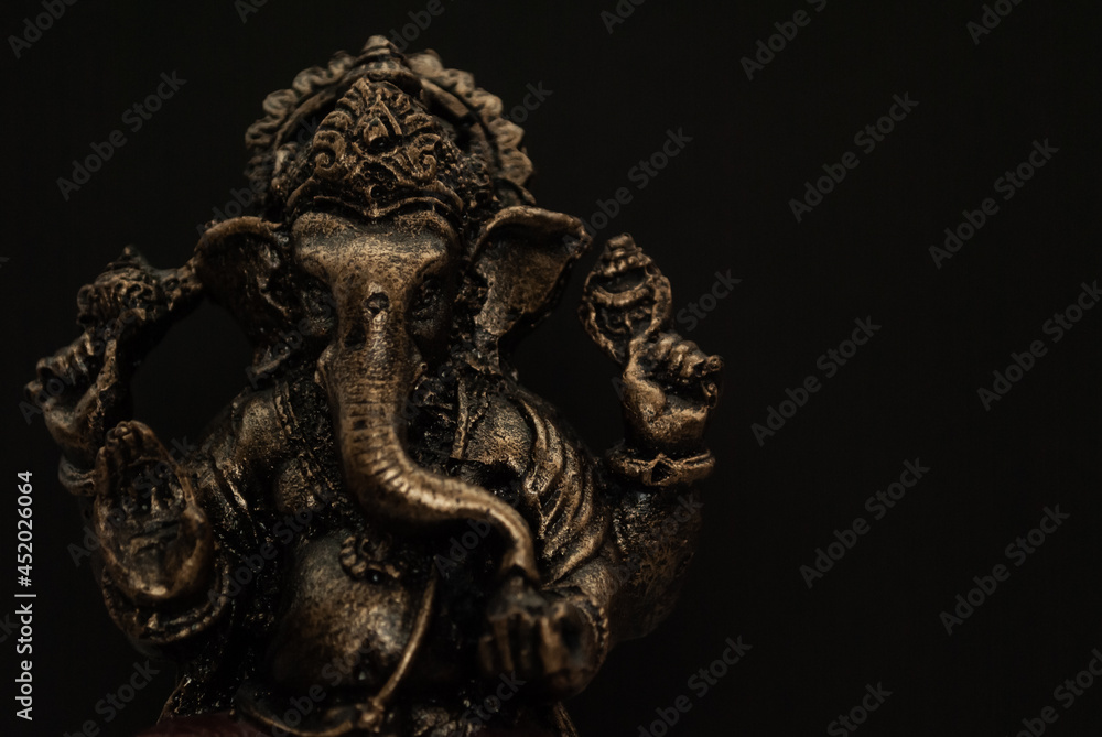 Souvenir figurine of the Indian god Ganesha on a black background
