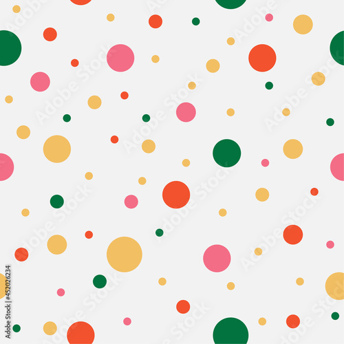 Colorful chaotic dots. Yellow, green, pink, orange circles on light background. Vector seamless pattern. Bright abstract texture for your design, paper, textile