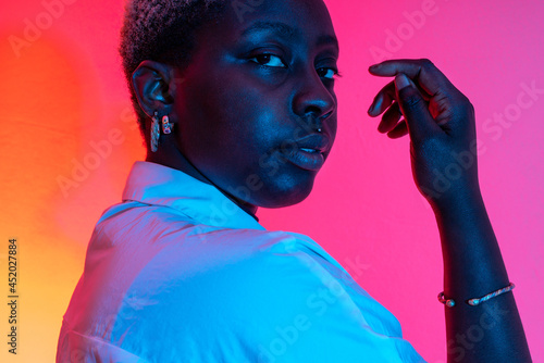 Tender black woman in stylish jewelry in studiovertical , horizontal photo