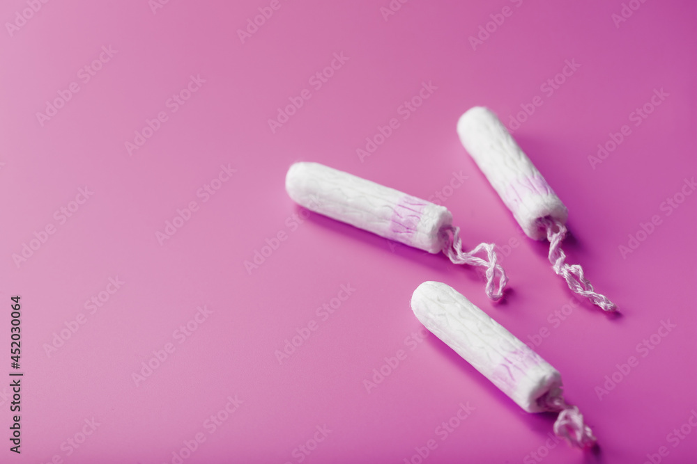 Cotton tampons on a pink background with a free space Cotton tampons on a pink background with a free space