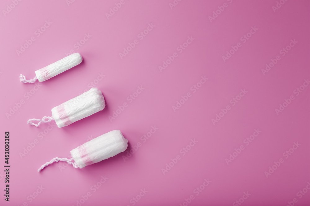 Cotton tampons on a pink background with a free space Cotton tampons on a pink background with a free space