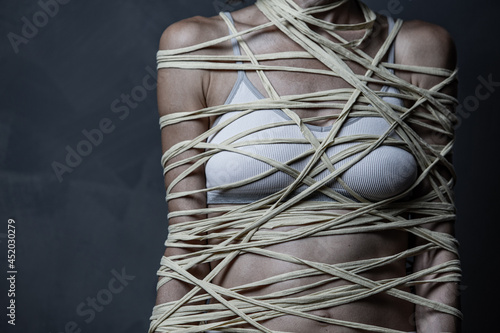 portrait of a person with a rope around a body concept shows problems, stress and tiredness