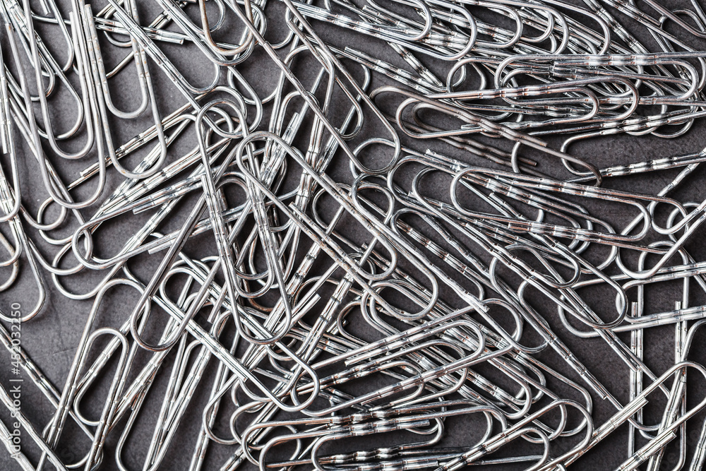 Silver paper clips textured background full screen Silver paper clips textured background full screen