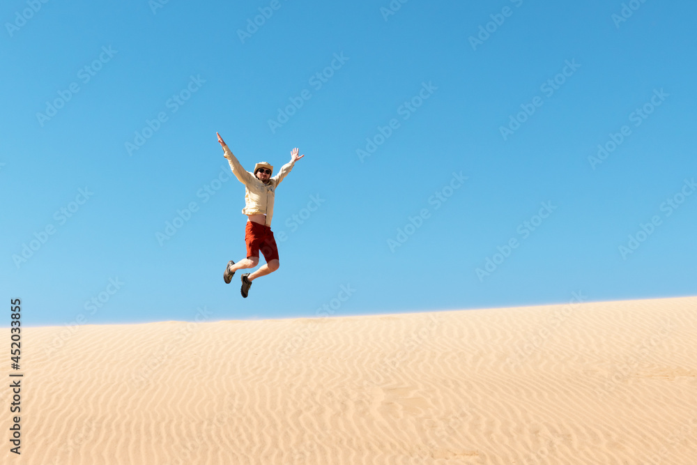 Single man throws sand in the Namib desert