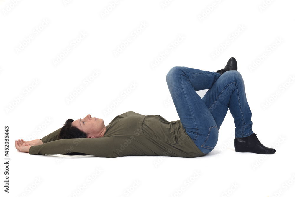 woman lying on the floor looking up and legs crossed on white background