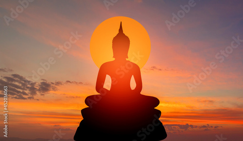 buddha silhouette on golden sunset background beliefs of Buddhism