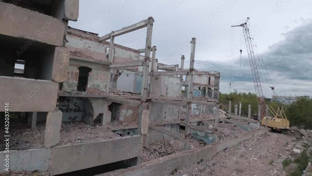 FPV drone flies quickly and maneuverable among abandoned industrial buildings and around an excavator. FPV drone flies quickly and maneuverable among abandoned industrial buildings and around an excavator.