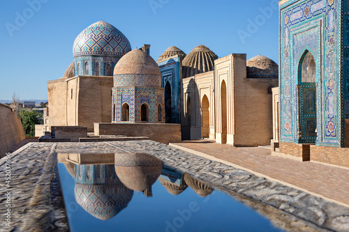 Photos Mausoleums and domes of the historical cemetery of Shahi Zinda and their reflections in puddle, Samarkand, Uzbekistan