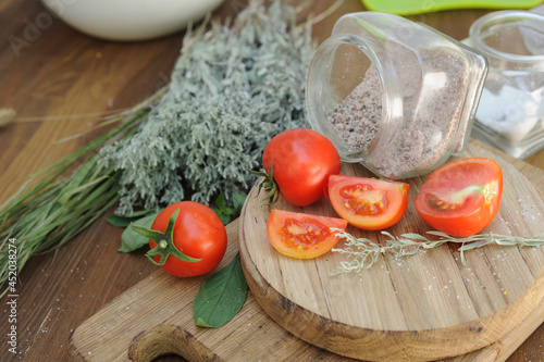 Ripe organic slised tomatoes on wooden cutting board photo